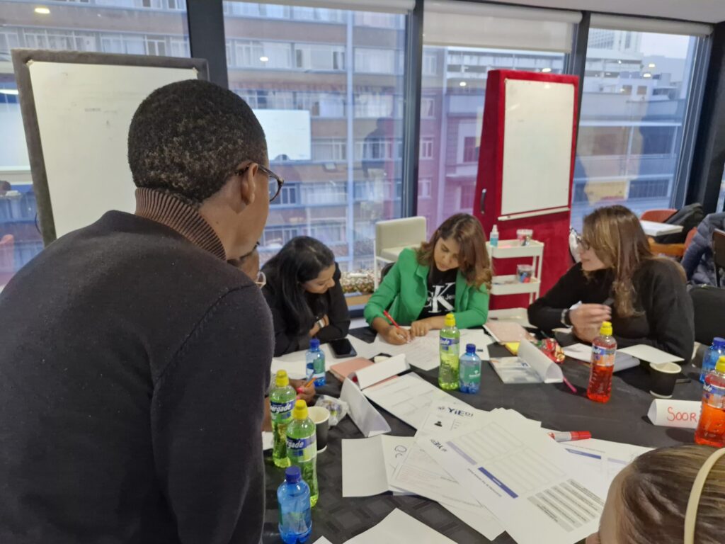 Entrepreneurs participating in a YIEDI SME development workshop, collaborating during a group activity
