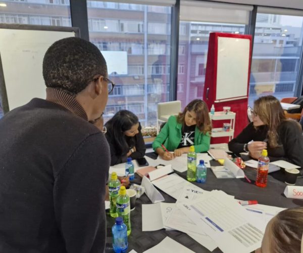 Entrepreneurs participating in a YIEDI SME development workshop, collaborating during a group activity